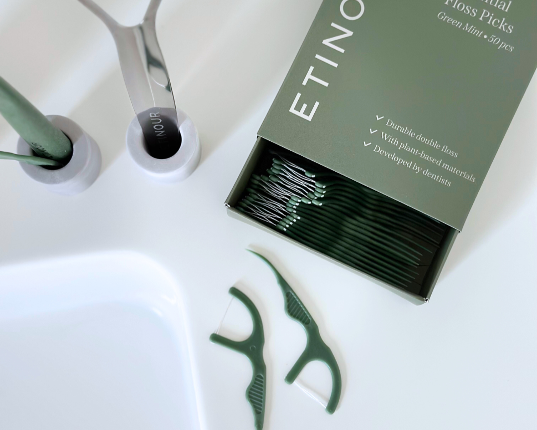 Floss picks paper packaging sliding box with floss picks neatly packaged on white bathroom countertop