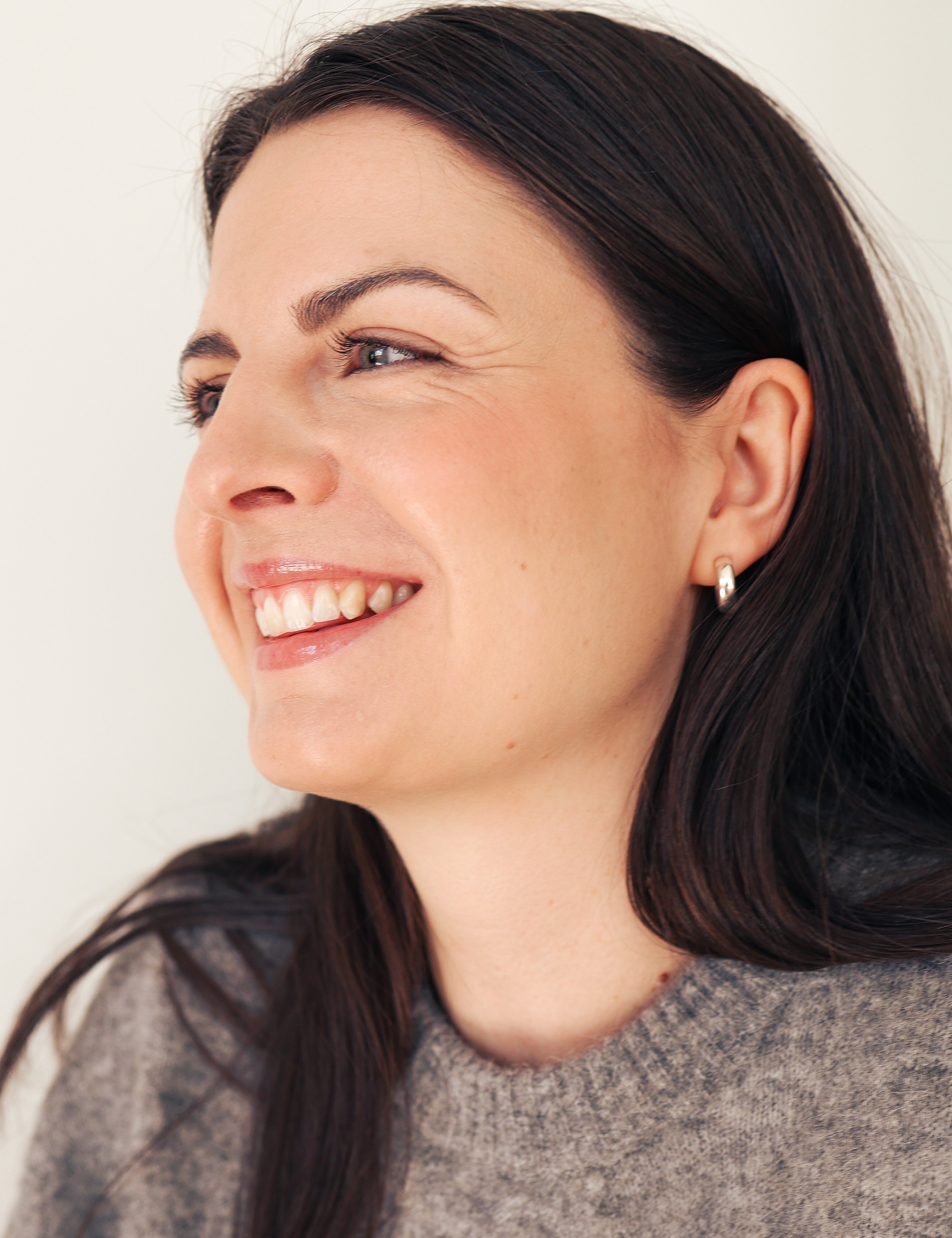 Young woman with beautiful smile looking to the side 