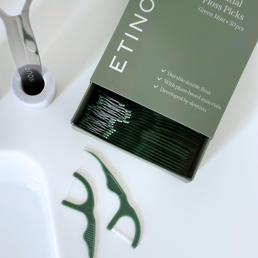 Floss picks paper packaging sliding box with floss picks neatly packaged on white bathroom countertop