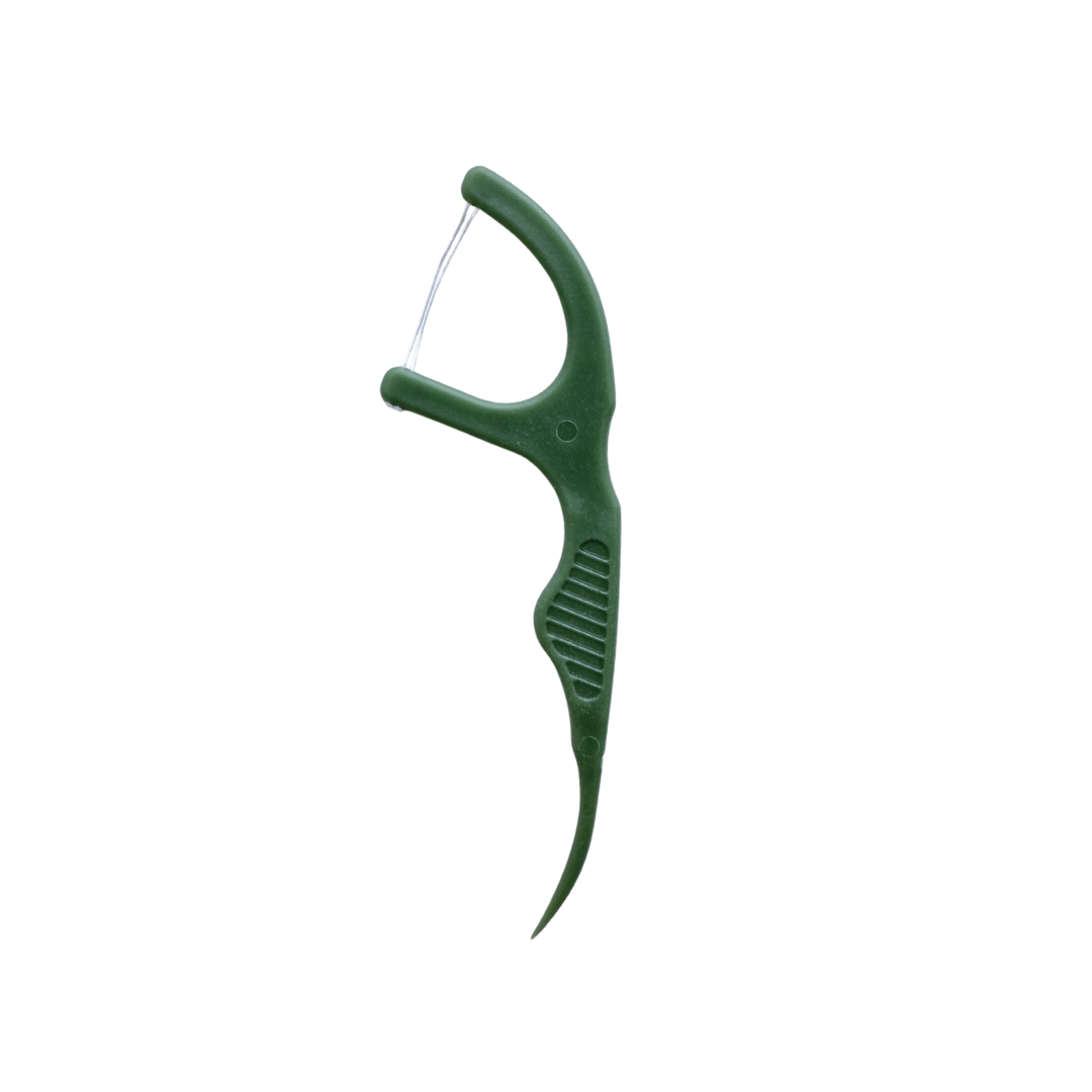 One green floss pick white background