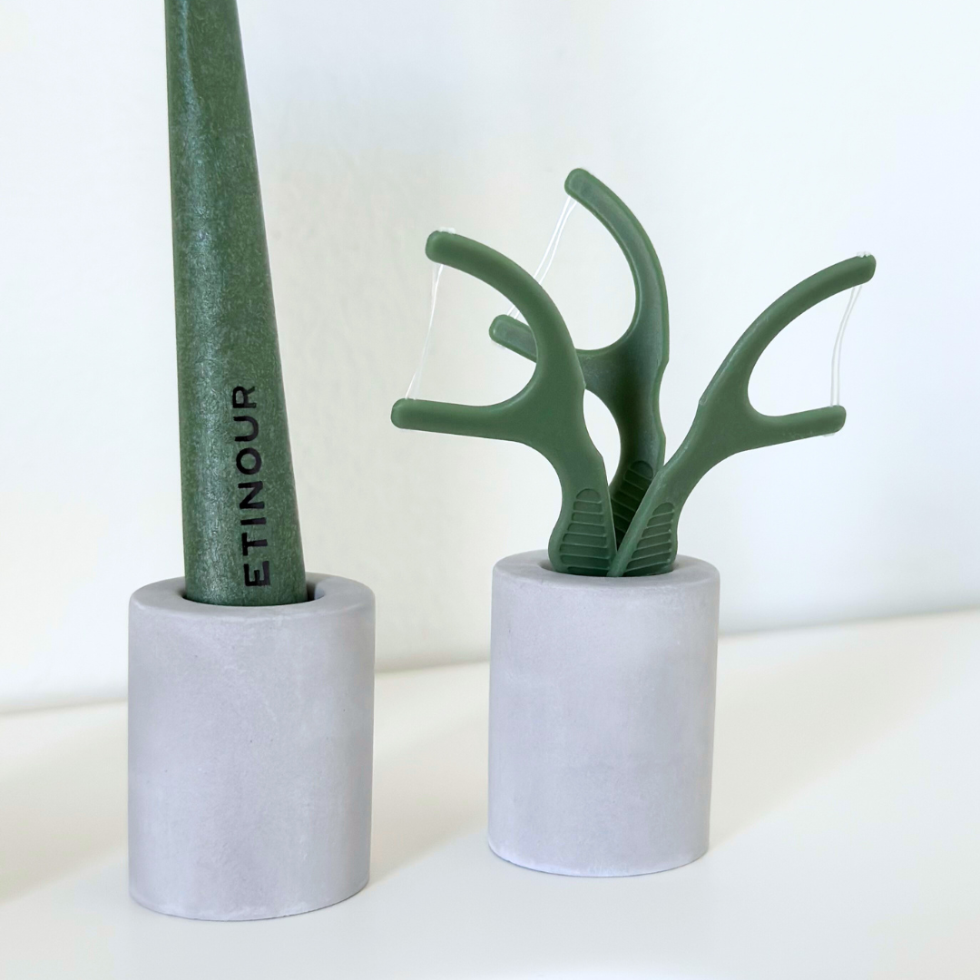 Zoom in on green essential toothbrush an floss picks in essential toothbrush holders grey