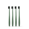 Four Etinour green Essential Toothbrushes next to each other on white background